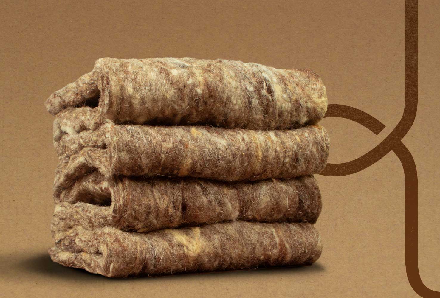 Four wool liners that have been stacked on top of eachother on a brown background with the Woolcool logo