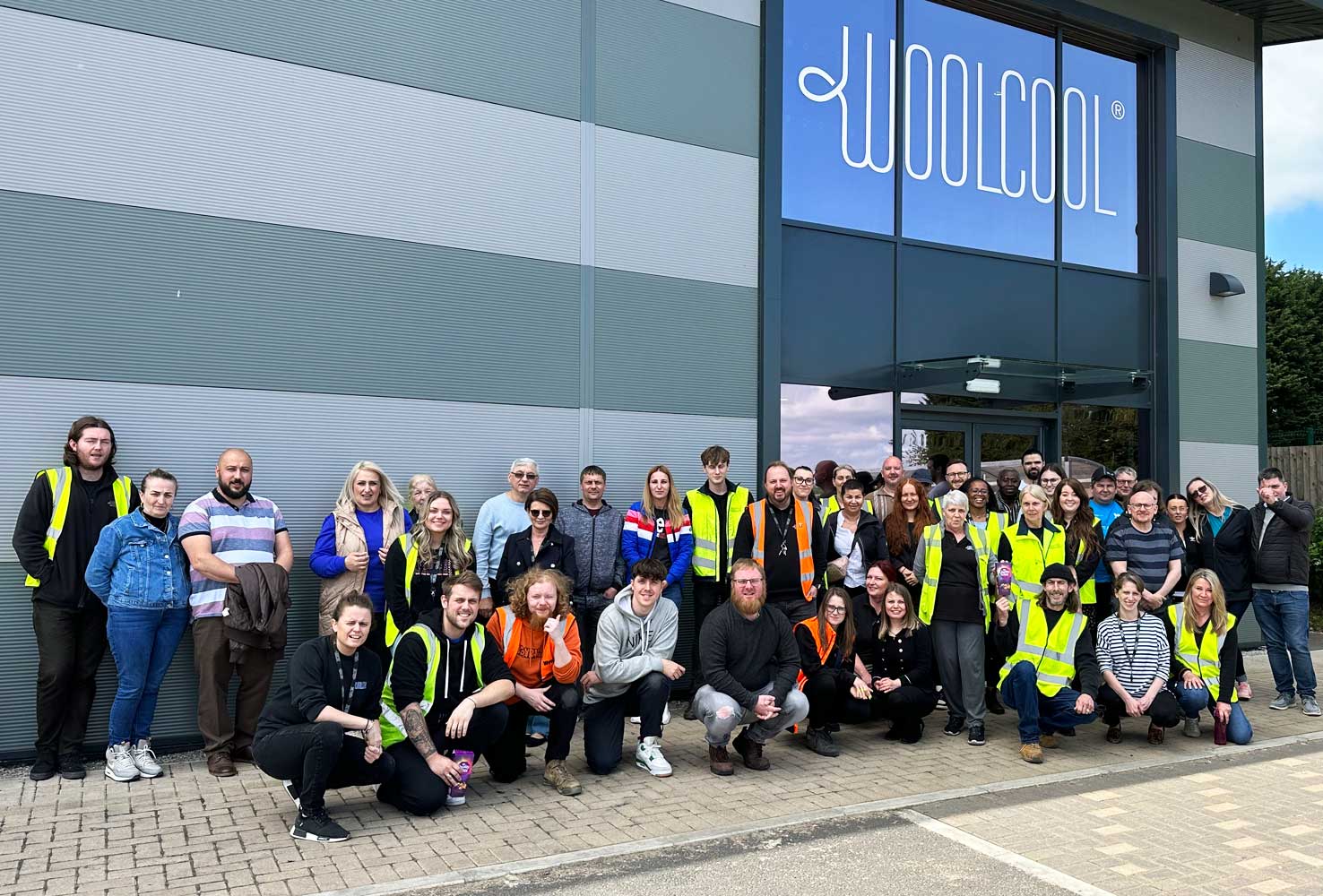 an image of the woolcool team, inlcuding office and warehouse staff posing for a photo outside of the Woolcool HQ