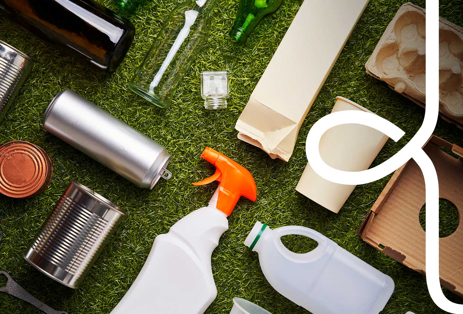 A selection of food cartons displayed on grass, With the Woolcool W logo overlapping