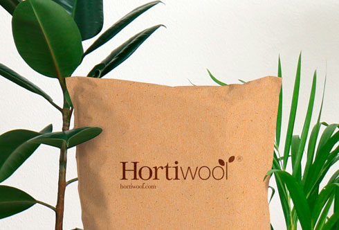 A hortiwool pouch surrounded by plants