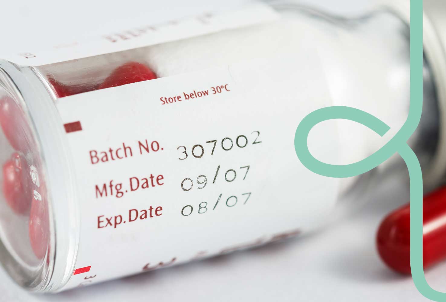 A medicine vial, showing a close up of a registration and bath number label. Over the top a Woolcool W icon overlaps.