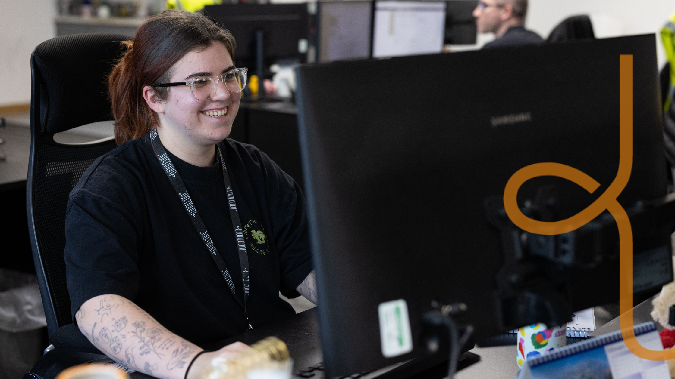 Smiling lady at her desk with the Woolcool logo
