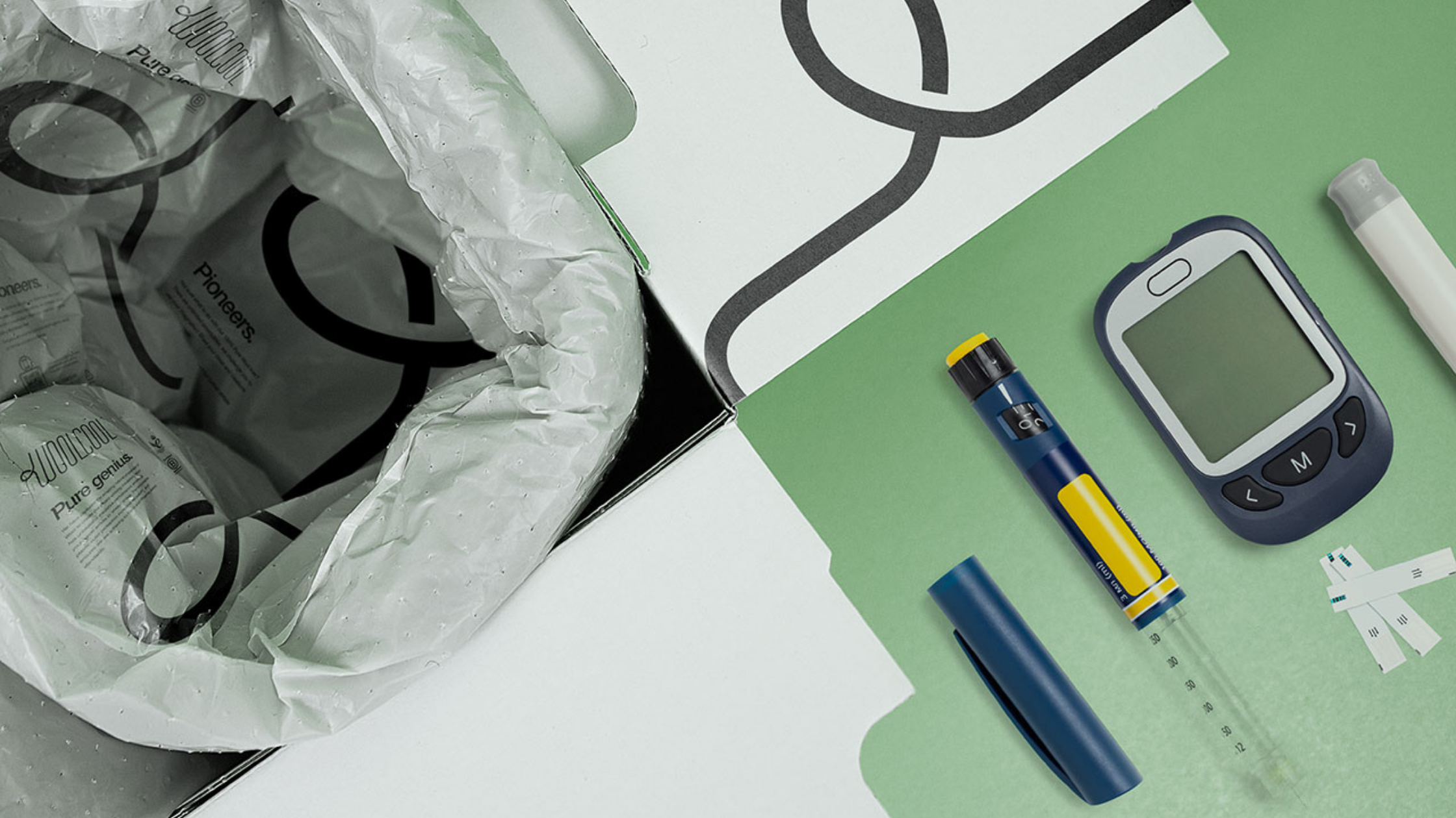 Woolcool packaging with pharmaceutical objects on a green background.