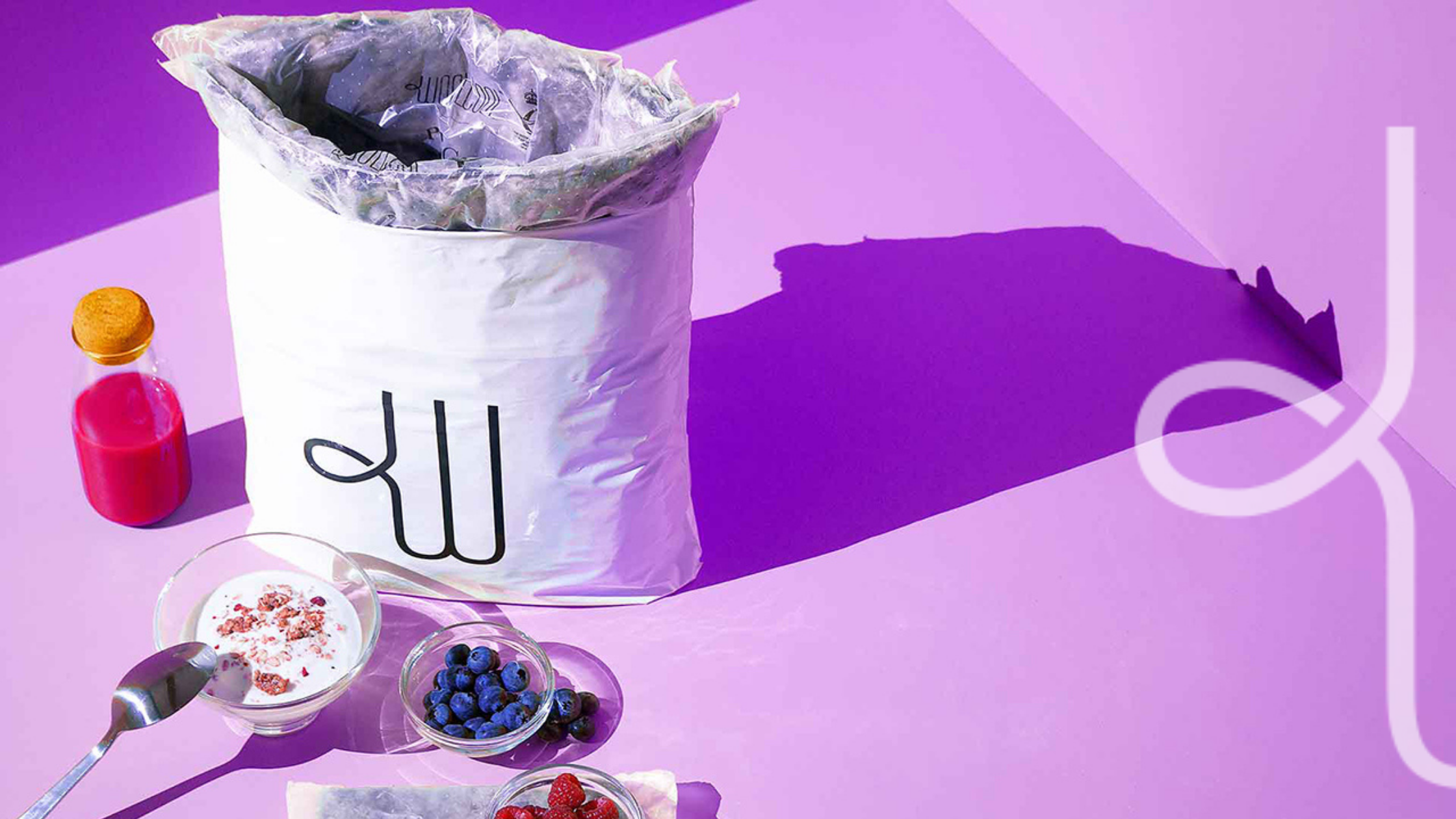 Woolcool packaging and food on a purple background with the Woolcool logo